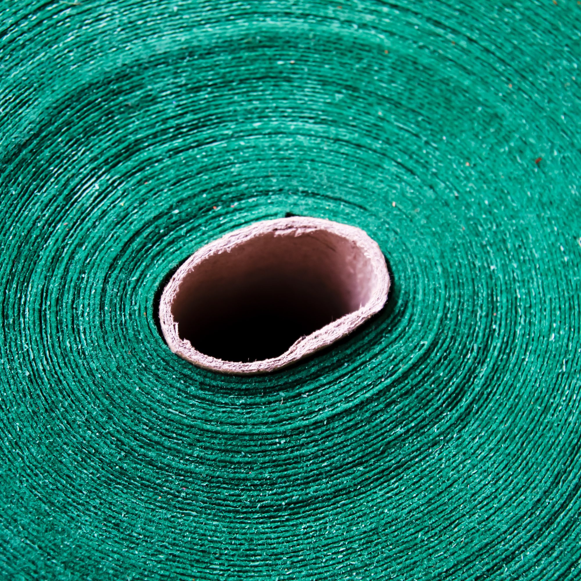 The roll of fabric raw material for the manufacturing process.